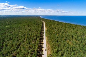 Fototapeta premium Aerial view of seaside forest and lonely road.