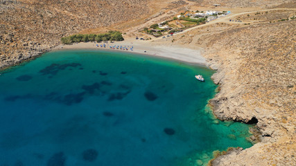 Aerial drone photo of paradise organised beach of Kaminakia with emerald clear sea and small caves, Astypalaia island, Dodecanese, Greece