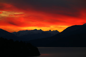 atardecer rojo y nublado sobre las montañas