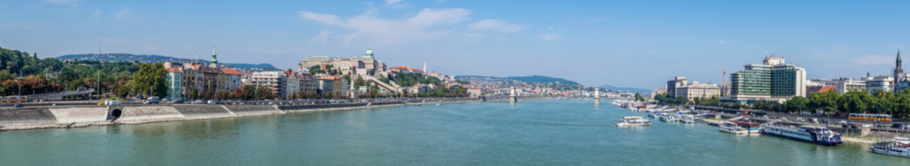 Fototapeta na wymiar Budapest, Hungary - August 29, 2019: the Danube River bridges and the panorama of Budapest, the capital of Hungary, in the summer. A tourist trip to the ancient metropolitan cities of Europe