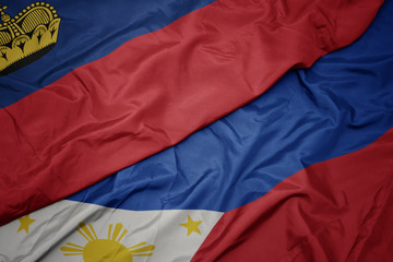waving colorful flag of philippines and national flag of liechtenstein.