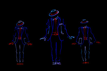 dancers in led suits on dark background, colored show
