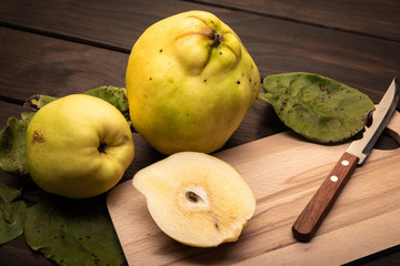 Fresh Quince fruit on wooden table