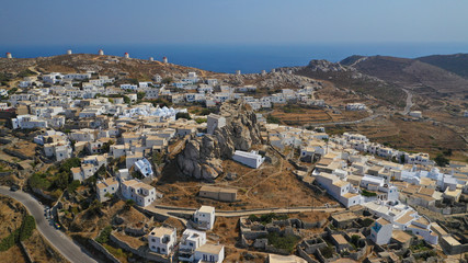Aerial drone panoramic photo of picturesque main village or chora and castle of Amorgos island built on top of cliff overlooking the Aegean blue sea, Cyclades, Greece