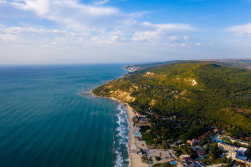 Fototapeta na wymiar Aerial view of beautiful blue beach with waves and yellow sand