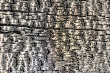 The texture of burnt wood. The remains of the house burned in the fire.