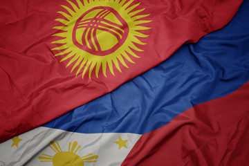 waving colorful flag of philippines and national flag of kyrgyzstan.