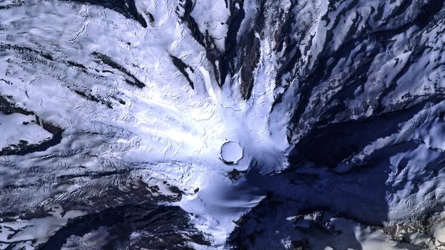 Sunrise on snowy mountains satellite aerial view night to day animation of Mount Rainer. Contains public domain image by Nasa