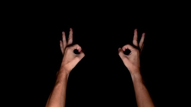 Perfecto validation hand symbol on a chroma key black screen, top down shot