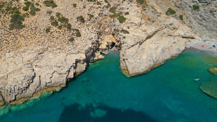 Aerial drone photo of paradise small beach of Mouros with caves and crystal clear sea, Amorgos...