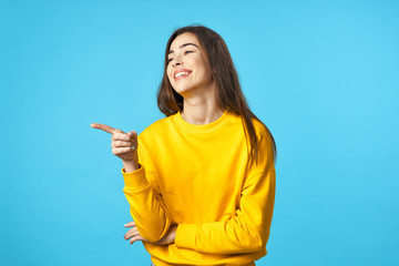 portrait of young woman pointing at copy space