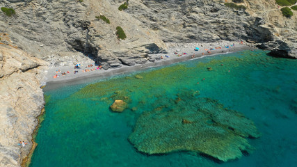 Aerial drone photo of paradise small beach of Mouros with caves and crystal clear sea, Amorgos...