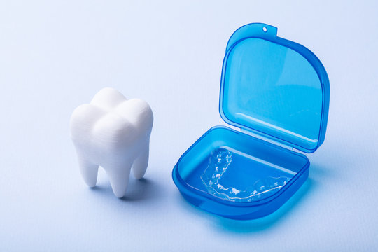 Dental Model And Case Of Mouth Guard Over Surface