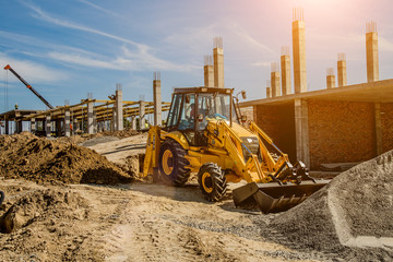 Construction site background. Hoisting cranes and new multi-storey buildings. I.ndustrial background.Building construction site work against blue sky