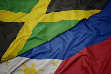 waving colorful flag of philippines and national flag of jamaica.
