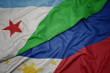 waving colorful flag of philippines and national flag of djibouti.