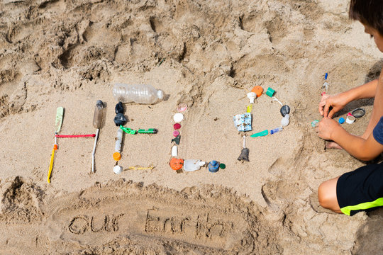 Close up view of the word HELP using waste collected by child