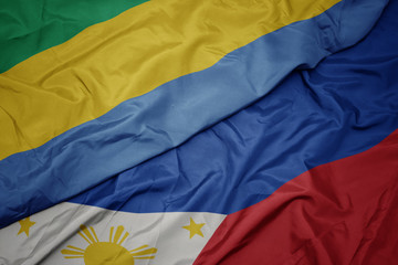 waving colorful flag of philippines and national flag of gabon.