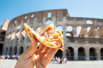 Hand Holding Italian Pizza Near Colosseum