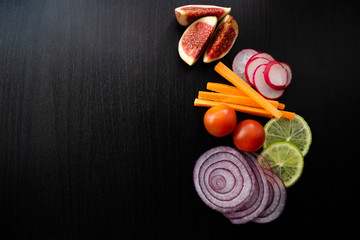 Seasonal vegetables and fruit on dark wooden background. Copy space