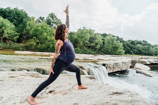Pregnant woman in extended triangle pose