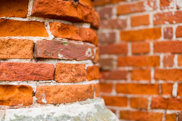 Part of an old brick post in focus and a brick wall in the background in defocus. Part of an abandoned building © Вячеслав Думчев