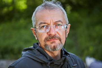 The serious face of an educated man 56 years old.