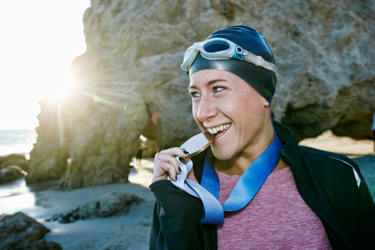 Swimmer on beach with medal