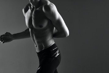 bodybuilder posing on black background