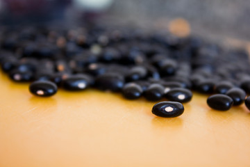 Food item - black beans grains with a warm and yellow background