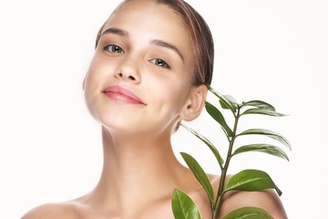 Beautiful woman naked shoulders palm leaves