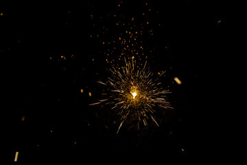 Sparks of a fire during the night, black background.