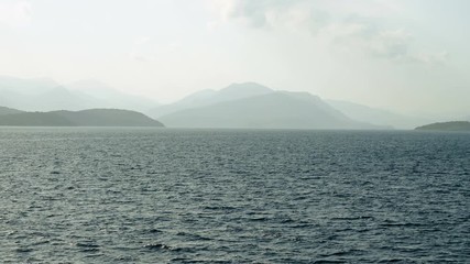 Rocky headland and scenic coastline of Corfu. Landscape of the Mediterranean sea in Greece at sunset. 4K