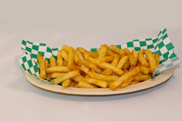 Crispy French Fries on checkered paper and plate