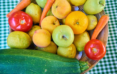 Still life of fruits and vegetables located on a table with green checkered tablecloth. Autumnal still life. Rustic design