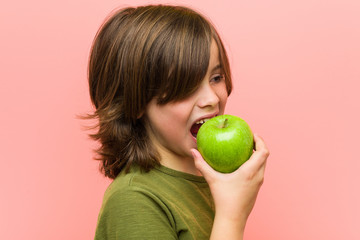 Little caucasian boy holding an apple