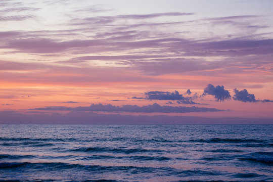 Sunset on the sea and beautiful violet orange sky
