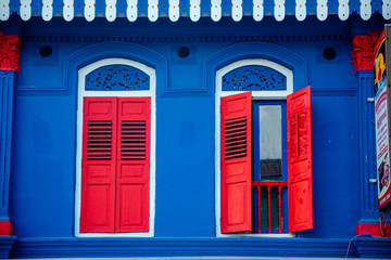 Obraz premium window with red shutters