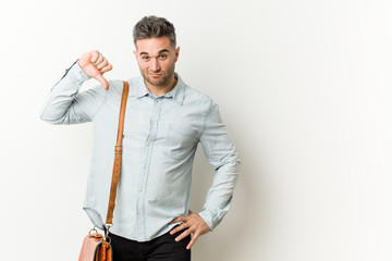 Young handsome business man showing a dislike gesture, thumbs down. Disagreement concept.