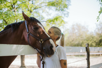 Young woman rider and her beautiful horse 