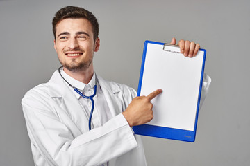 young doctor with blank clipboard