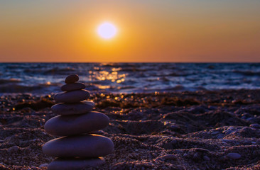 Zen concept. Sunset. The object of the stones on the beach at sunset.