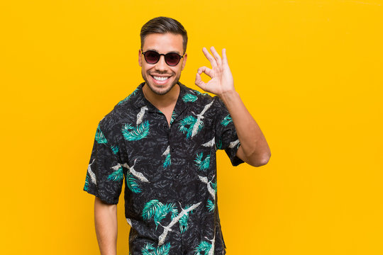 Young filipino man wearing summer clothes cheerful and confident showing ok gesture.