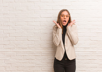 Young pretty business entrepreneur woman surprised and shocked
