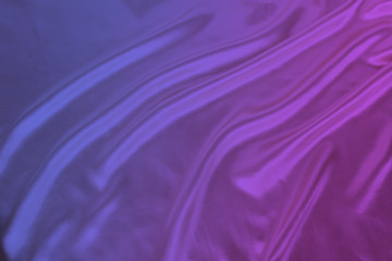 soft folds on bright purple shiny silk, luxury concept, background for the designer, horizontal, close-up, copy space