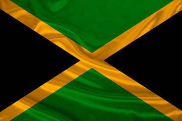 photo of the national flag of the state of Jamaica on a luxurious texture of satin, silk with waves, folds and highlights, close-up, copy space, illustration