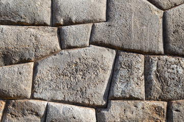 Giant granite boulders and the finest Inca stonework of the Inca civilization with an Inca wall in the archaeological ruin of Sacsayhuaman, Cusco City, Peru.