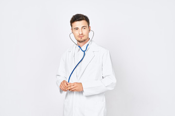 Fototapeta premium portrait of a young doctor with stethoscope isolated on white