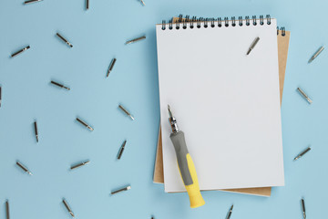 master's desk with a blank notebook and set of hand tools