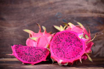 Red dragon fruit on wooden background